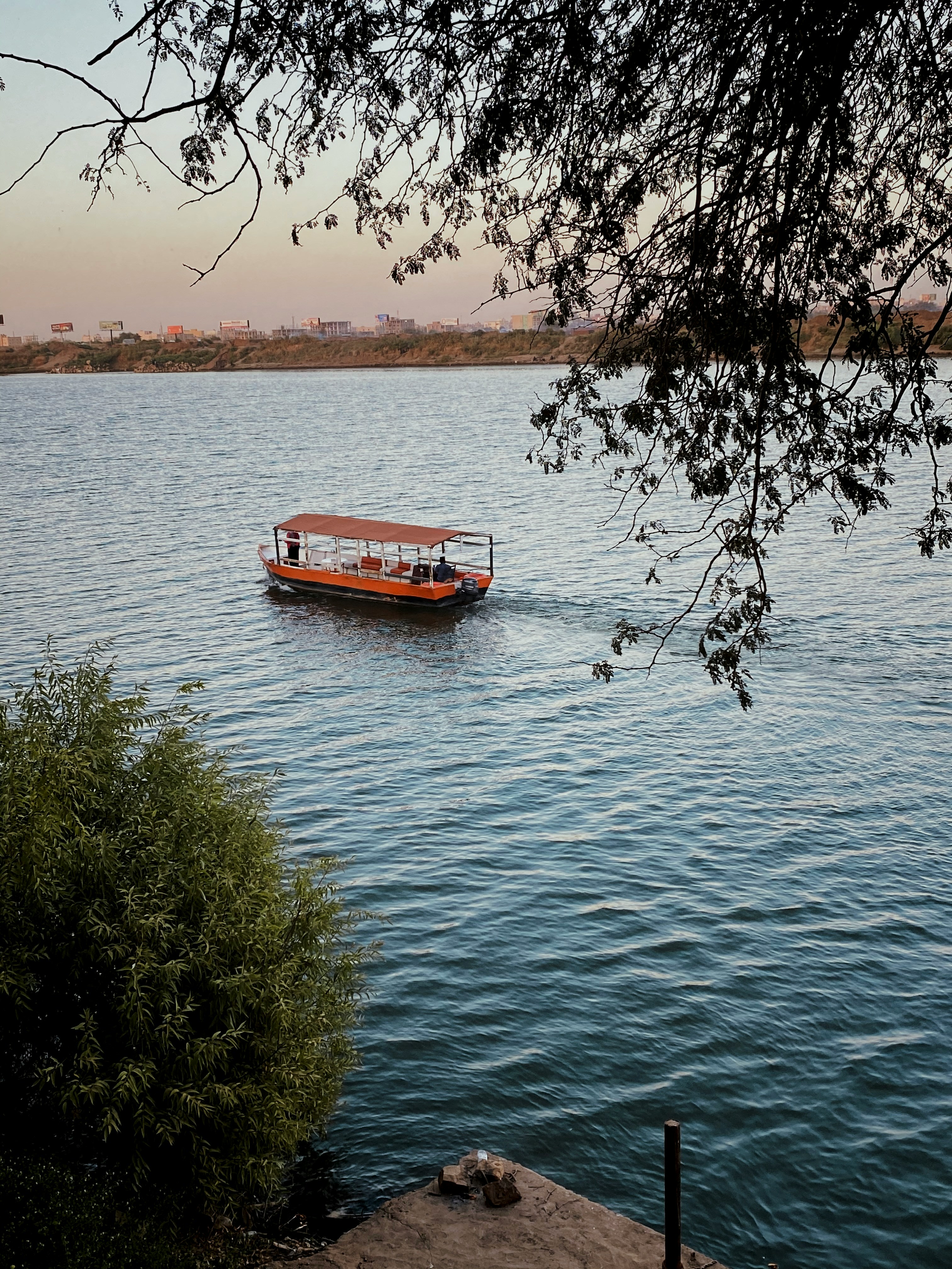 Red boat on body of water near Khartoum, Sudan